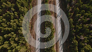 Traffic cars on highway road between deep forest