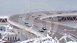 Traffic of cars on a highway at winter frosty morning in the city.