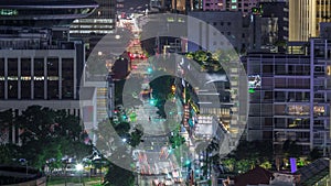 Traffic with cars on a street and urban scene in the central district of Singapore night timelapse