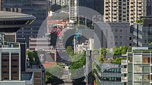 Traffic with cars on a street and urban scene in the central district of Singapore timelapse