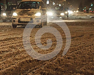 Traffic in the city cars bad weather and snow blizzard by night
