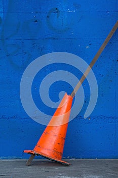 Traffic cone and blue wall