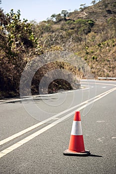 Traffic cone close up in the middle of a road.