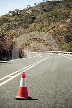 Traffic cone close up in the middle of a road.