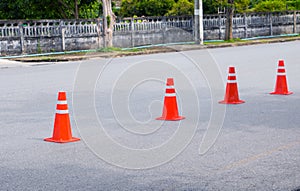 Traffic cone row old orange and swath white stripes on the road with copy space