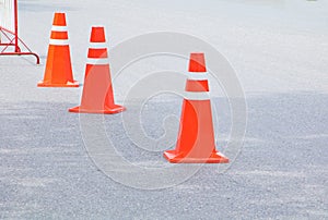 Traffic cone row old orange and swath white stripes on the road with copy space