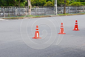 Traffic cone row old orange and swath white stripes on the road with copy space