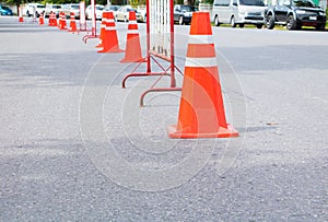 Traffic cone row old orange and swath white stripes on the road with copy space