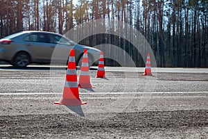 Traffic cones are exposed on the pavement during the repair of the intercity road. Highway traffic during pavement repair