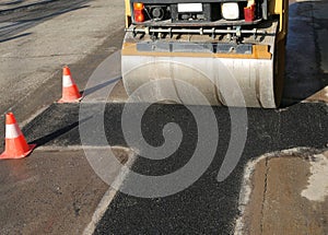 traffic cones and a heavy road roller