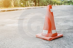 Traffic cones are located on the cement surface. In the park to protect the danger