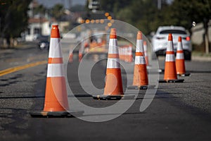 Traffic cones on road with electronic arrow pointing to the right to divert traffic photo