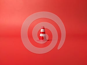 Traffic cones roadblock,mini traffic signs on a red background photo