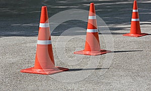 Traffic cones standing in a row on the road
