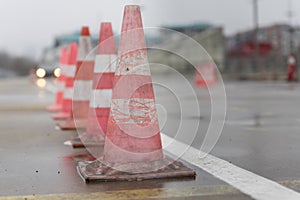 Traffic cones on the wet road. Caution ,danger, warning signs