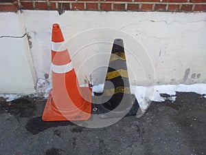 Traffic cones with yellow & grey strips and white & orange