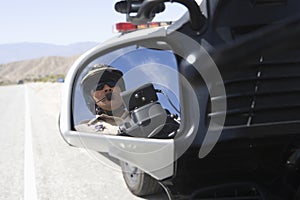 Traffic Cop Reflecting In Side View Mirror