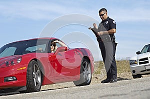 Traffic Cop Standing By Sports Car