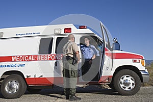 Traffic Cop Talking With EMT Doctor photo