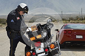 Traffic Cop Writing Against Motorcycle