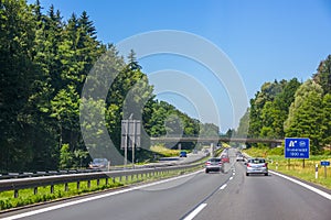 Traffic on a Country Highway in Summer Sunny Day