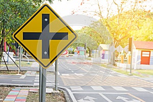 Traffic crossroads. A road sign warns of an intersection ahead.