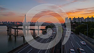 Traffic at gwangnaru bridge river bank during sunset in seoul city south kore