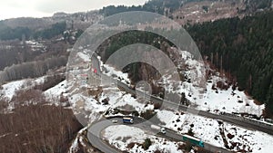 Traffic on high mountain pass road in winter , aerial view