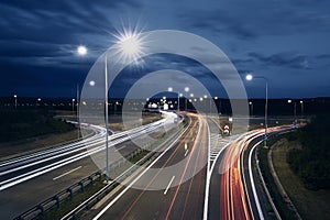 Traffic on illuminated highway at night