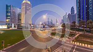 Traffic on intersection and bridge at the Sheikh Zayed Road day to night timelapse