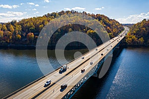 Traffic on the interstate through fall colors on Cheat Lake Morgantown, WV with I68 bridge