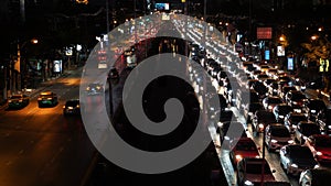 Traffic jam on the Avenue at rush hour in the city center at night time, urban cityscape