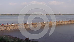 Traffic jam on the bamboo bridge over the Mekong River  time lapse