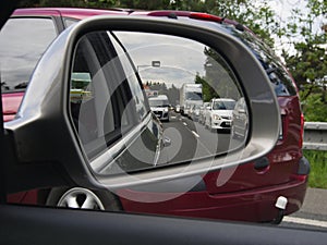 Traffic jam on the highway displayed in the rearview mirror