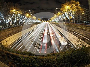 Traffic jam in madrid castilla place at night with car lights tracks