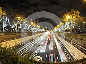 Traffic jam in madrid castilla place at night with car lights tracks