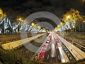 Traffic jam in madrid castilla place at night with car lights tracks