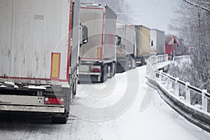 Traffic jam of trucks in snowstorm