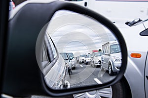 Traffic jam view through a car mirror