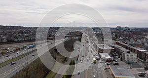 Traffic in large city. Vehicles driving on busy road in urban neighbourhoods. Aerial view of bridge over highway. Boston