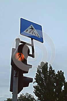 Traffic light in amber indicating a pedestrian crossing.
