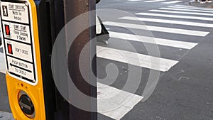 Traffic light button on pedestrian crosswalk, people have to push and wait. Traffic rules and regulations for public