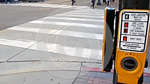 Traffic light button on pedestrian crosswalk, people have to push and wait. Traffic rules and regulations for public