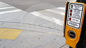 Traffic light button on pedestrian crosswalk, people have to push and wait. Traffic rules and regulations for public