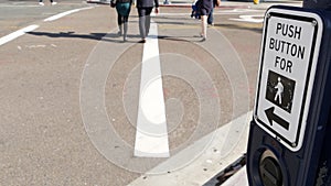 Traffic light button on pedestrian crosswalk, people have to push and wait. Traffic rules and regulations for public