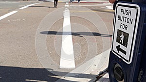 Traffic light button on pedestrian crosswalk, people have to push and wait. Traffic rules and regulations for public safety in USA