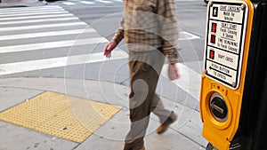 Traffic light button on pedestrian crosswalk, people have to push and wait. Traffic rules and regulations for public safety in USA