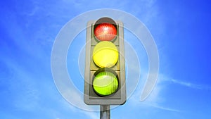 Traffic light color change from red in yellow and green