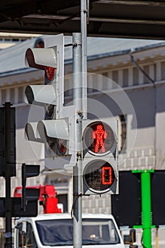 Traffic light with forbidding red signal for pedestrians on the city street closeup