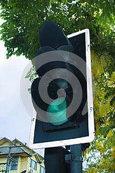 Traffic light with green color in the city street